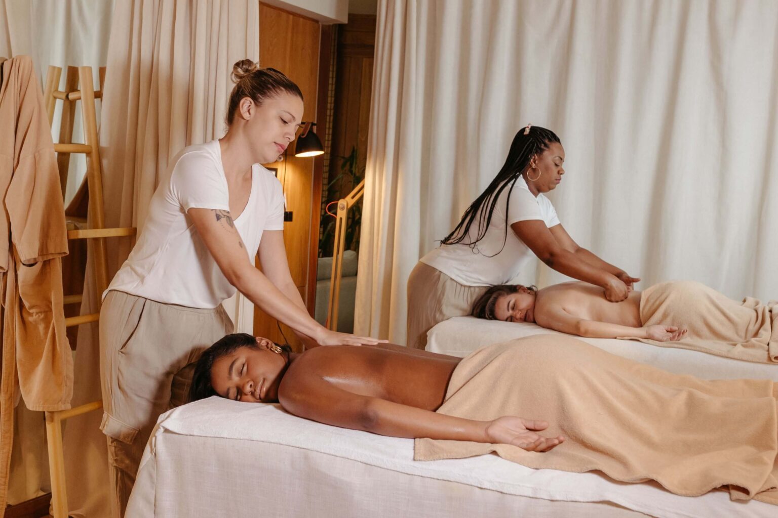 Students practicing Swedish massage techniques in a wellness training setting