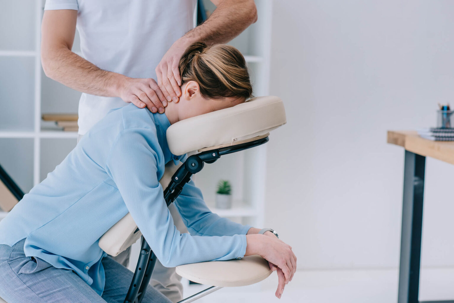 Massage therapist applying hands-on technique during a back massage